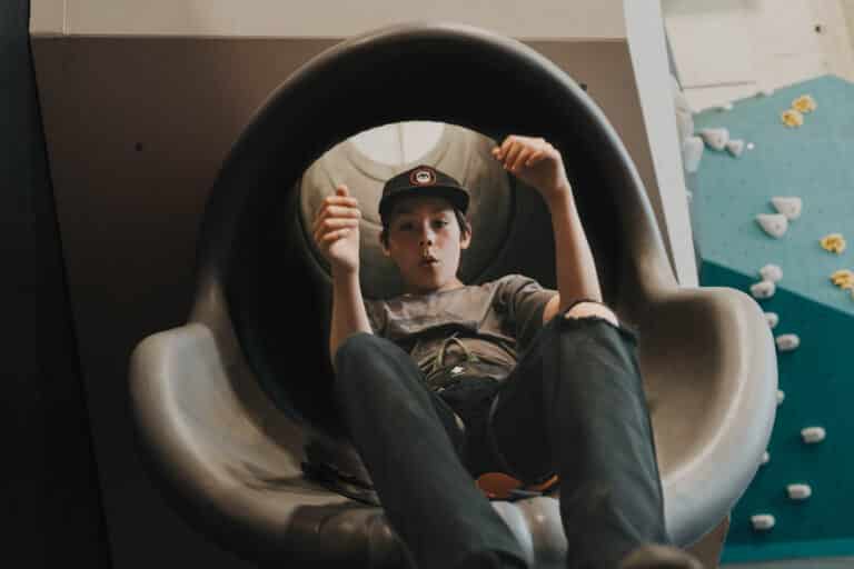 Child exits a slide in the Gravity Lab at Climb So iLL.