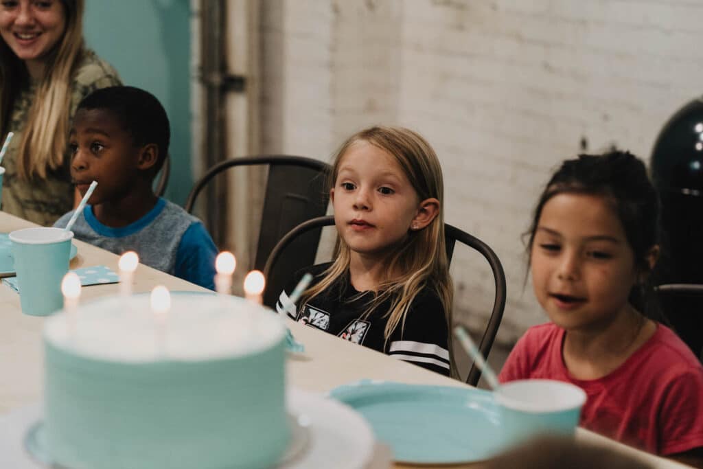 Children get ready to eat cake in the Gravity Lab at Climb So iLL.