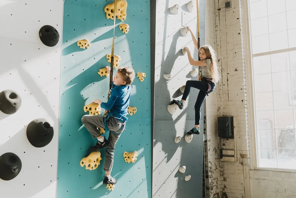 Boy and girl climb walls in the Gravity Lab in St. Charles.